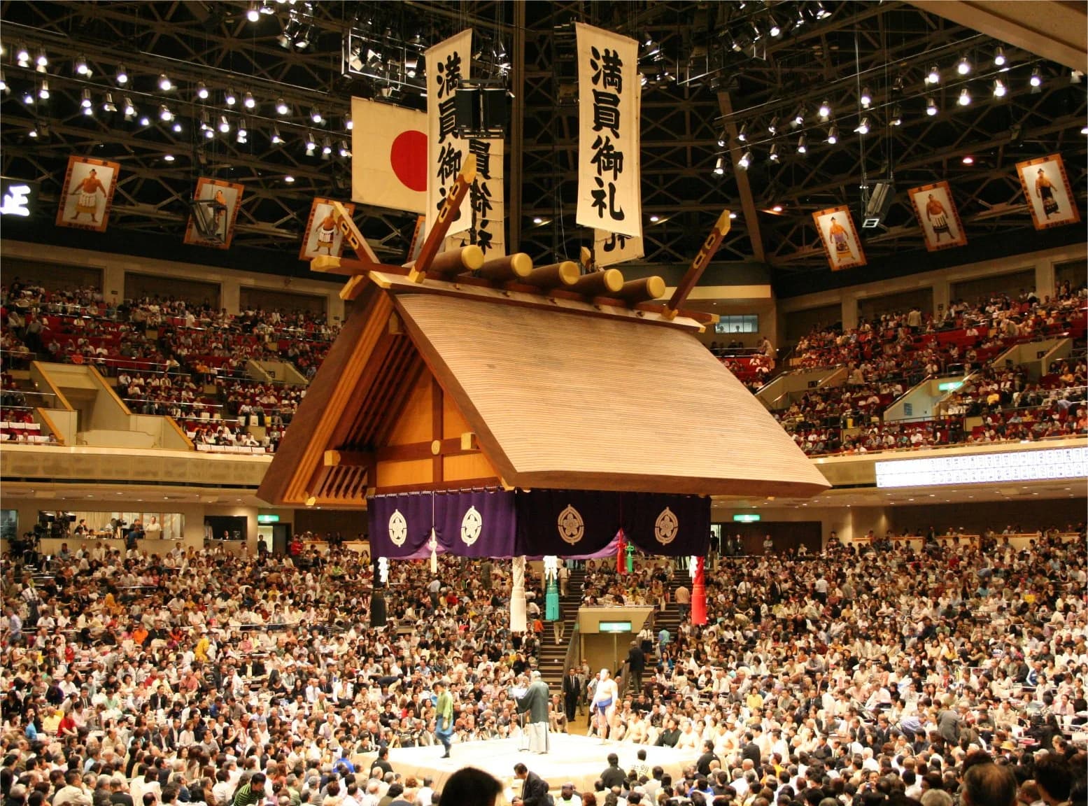 The tsuriyane - the suspended Shintō-shrine-style canopy above the dohyō at Ryōgoku Kokugikan, with the four directional tassels visible at each corner.